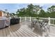 Deck with an outdoor grill, table, and chairs, ideal for summer barbecues and outdoor dining at 139 Grandmar Chase, Canton, GA 30115