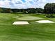 Beautiful golf course showcasing lush green fairways, manicured greens, and pristine sand traps under a sunny sky at 139 Grandmar Chase, Canton, GA 30115