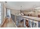 Upstairs hallway with decorative railing overlooking the stairs and hardwood floors at 139 Grandmar Chase, Canton, GA 30115