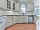 Well-lit kitchen with stainless steel appliances, and pristine white cabinets at 139 Grandmar Chase, Canton, GA 30115