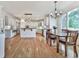 Bright kitchen boasts white cabinetry, stainless steel appliances, a breakfast nook, and large windows overlooking the backyard at 139 Grandmar Chase, Canton, GA 30115