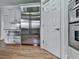 Modern kitchen features a large stainless steel refrigerator and white cabinets with granite countertops at 139 Grandmar Chase, Canton, GA 30115