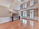 Bright living room with hardwood floors, a large painting, and natural light from multiple windows at 139 Grandmar Chase, Canton, GA 30115