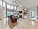 Spacious living room features a fireplace, built-in shelving, hardwood floors, and expansive windows with natural light at 139 Grandmar Chase, Canton, GA 30115
