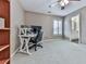 Office area with neutral walls and carpet, a window with shutter-style blinds, and a peek into the bathroom at 139 Grandmar Chase, Canton, GA 30115