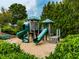 Community playground featuring a wooden structure with green slides surrounded by lush landscaping at 139 Grandmar Chase, Canton, GA 30115