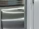 Close-up of a stainless steel Sub-Zero refrigerator in a modern kitchen with white cabinets at 139 Grandmar Chase, Canton, GA 30115