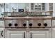 Close-up of a high-end Thermador stovetop with six burners on a granite countertop at 139 Grandmar Chase, Canton, GA 30115