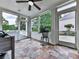 Bright sunroom with large windows, stone tile floor, and views of the outdoor landscape at 139 Grandmar Chase, Canton, GA 30115