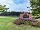 Community Racquet Club, featuring brick signage, blooming flowers, and a tennis court, enhancing the neighborhood amenities at 139 Grandmar Chase, Canton, GA 30115
