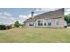 View of the home's exterior showcasing an expansive backyard and complementary siding and window design at 4217 Brentwood Dr, Buford, GA 30518
