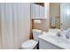 Functional bathroom with a single sink vanity, toilet, and shower with curtain at 4217 Brentwood Dr, Buford, GA 30518