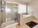 Bright bathroom featuring separate shower and tub with large window at 4217 Brentwood Dr, Buford, GA 30518
