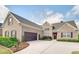 Charming brick home featuring manicured landscaping, a two-car garage, and a welcoming front entrance at 4217 Brentwood Dr, Buford, GA 30518