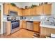 Modern kitchen with stainless steel appliances, light wood cabinetry, and hardwood floors for a contemporary look at 4217 Brentwood Dr, Buford, GA 30518