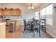 Bright kitchen with stainless steel appliances, light wood cabinets, and a dining area with large windows at 4217 Brentwood Dr, Buford, GA 30518