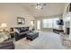 Inviting living room featuring a comfortable leather sofa, brick fireplace, and a wall-mounted television at 4217 Brentwood Dr, Buford, GA 30518