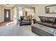 Cozy living room with dark leather furniture, plush carpet, decorative lighting, and an inviting atmosphere at 4217 Brentwood Dr, Buford, GA 30518