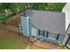 Aerial view of a blue house with a gray roof, landscaping, and a fenced backyard at 6597 Ivy Log Dr, Austell, GA 30168