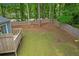 Expansive backyard with a wooden deck, surrounded by a tall privacy fence and mature trees at 6597 Ivy Log Dr, Austell, GA 30168