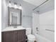 This bathroom has a tub, tile surround, single sink vanity, and a large framed mirror at 6597 Ivy Log Dr, Austell, GA 30168