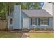 Charming blue home with a well-maintained front yard, black shutters and chimney at 6597 Ivy Log Dr, Austell, GA 30168