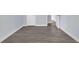 This is a view of the wood-look flooring leading into a doorway with light blue walls at 6597 Ivy Log Dr, Austell, GA 30168