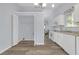 Kitchen with white cabinets, laundry area, wood floors, and modern appliances at 6597 Ivy Log Dr, Austell, GA 30168