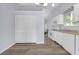Updated kitchen with white cabinets, wood floors, laundry area, and bright lighting at 6597 Ivy Log Dr, Austell, GA 30168