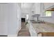 Bright kitchen featuring white cabinets, granite countertops, and modern appliances at 6597 Ivy Log Dr, Austell, GA 30168