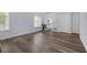 Bright living room featuring stylish wood floors, large windows, and access to the kitchen at 6597 Ivy Log Dr, Austell, GA 30168