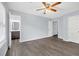 Main bedroom features wood-look floors, light blue walls, and adjoins a bathroom at 6597 Ivy Log Dr, Austell, GA 30168