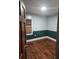 Charming bedroom featuring wooden floors, light blue and dark green walls and a window at 3238 Washington Rd, Atlanta, GA 30344