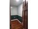 Bedroom featuring dark hardwood floors, white trim, and green and white paint at 3238 Washington Rd, Atlanta, GA 30344