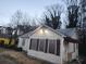 Exterior view of single-story home with cream siding, brown shutters, and mature trees at 3238 Washington Rd, Atlanta, GA 30344