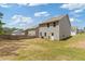 Back view of home featuring a grassy area and fence surrounding the property at 3475 Ridge Hill Pkwy, Douglasville, GA 30135