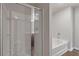 This bathroom includes a glass enclosed shower, bathtub, and modern fixtures at 3475 Ridge Hill Pkwy, Douglasville, GA 30135