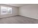 Bright bedroom with large window overlooking the yard and plush carpet at 3475 Ridge Hill Pkwy, Douglasville, GA 30135