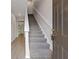 Entryway featuring a staircase with carpeted steps and a view into the living area with wood flooring at 3475 Ridge Hill Pkwy, Douglasville, GA 30135