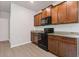 Modern kitchen boasts granite counters, dark wood cabinets, and stainless steel microwave and range at 3475 Ridge Hill Pkwy, Douglasville, GA 30135