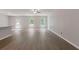 Spacious living room with wood floors, two windows, and a door leading to the backyard at 3475 Ridge Hill Pkwy, Douglasville, GA 30135