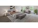 Beautifully staged main bedroom with neutral colors, large bed, and two windows at 3475 Ridge Hill Pkwy, Douglasville, GA 30135
