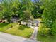 Aerial shot of a charming home with a well-manicured lawn and mature trees in a suburban setting at 4002 Lindsey Dr, Decatur, GA 30035