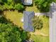 Aerial view of a home with a large lawn, mature trees, and a driveway leading to the street at 4002 Lindsey Dr, Decatur, GA 30035