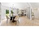 Modern dining area with a contemporary chandelier, flowing into a bright kitchen, and outdoor access at 4002 Lindsey Dr, Decatur, GA 30035