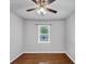 Cozy bedroom features hardwood floors, a ceiling fan, and a window for natural light at 844 Oak Nw St, Atlanta, GA 30318