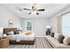 This bright bedroom features neutral walls, a ceiling fan, a large window, and comfortable seating at 844 Oak Nw St, Atlanta, GA 30318