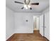 Comfortable bedroom with wood floors, ceiling fan, neutral walls, and an attached closet for ample storage at 844 Oak Nw St, Atlanta, GA 30318