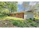 Brick ranch home featuring a manicured lawn, mature trees and plants at 844 Oak Nw St, Atlanta, GA 30318