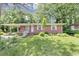 Charming single-story brick home with a covered porch and well-maintained front yard landscaping at 844 Oak Nw St, Atlanta, GA 30318